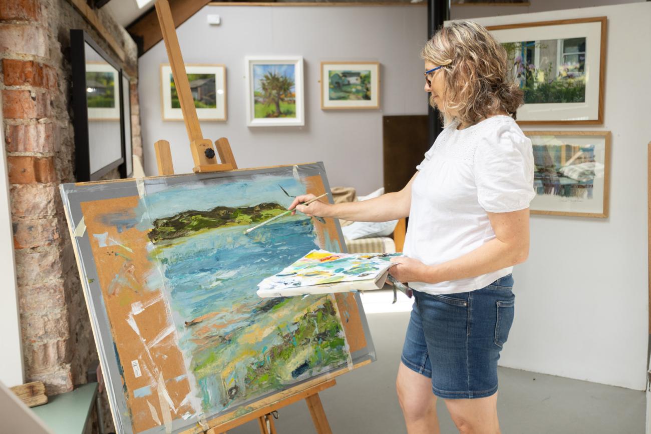 Kate Rebbeck painting in her studio